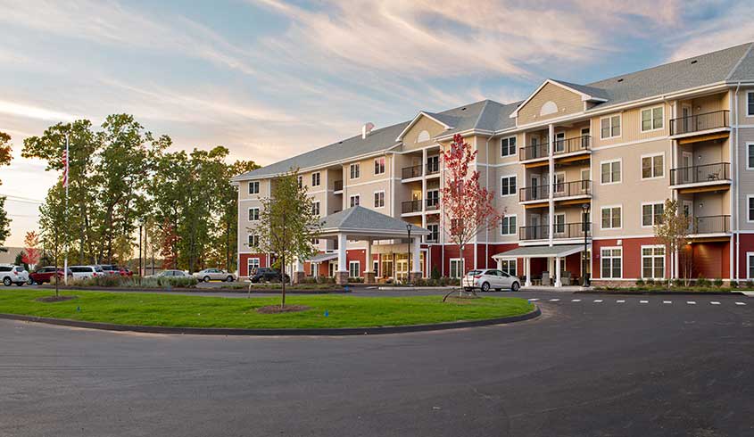 A modern residential apartment building with a landscaped entrance.