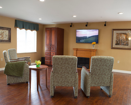 A cozy living room setup featuring comfortable armchairs, a television, and a warm ambiance.