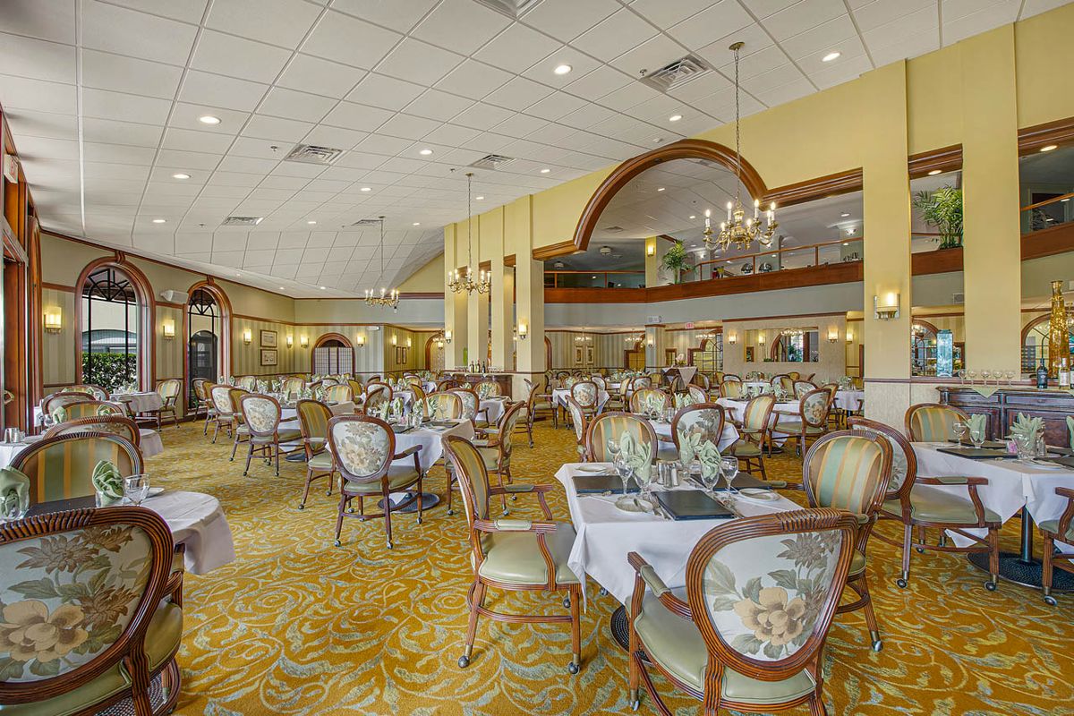 An elegant restaurant dining area with beautifully arranged tables and classic decor.