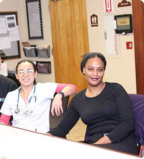 A group of colleagues sitting together in an office setting.