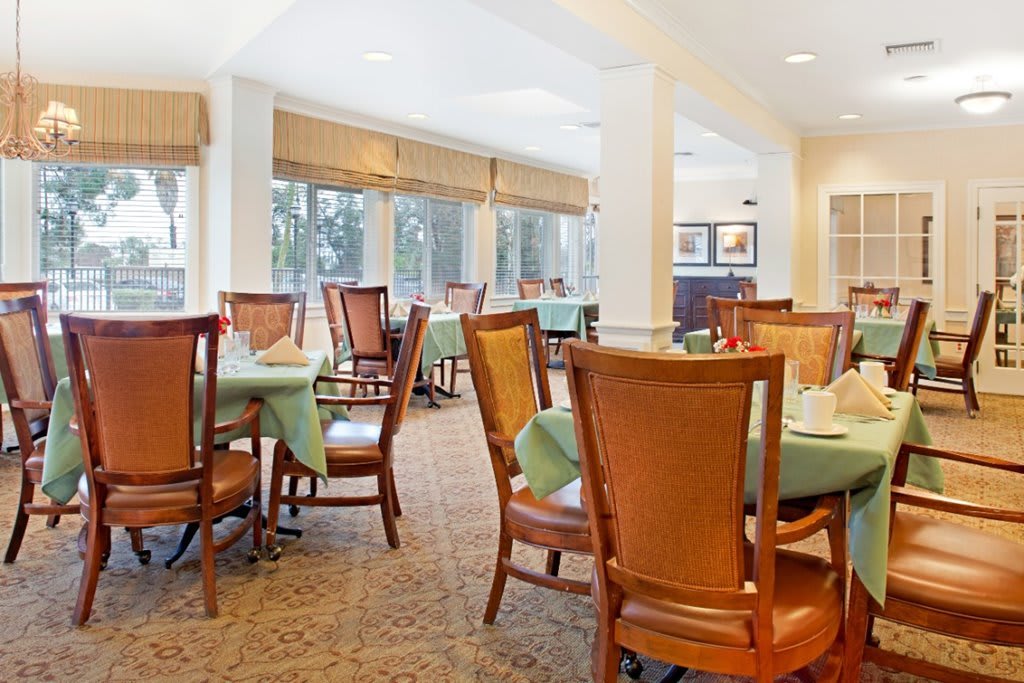 A well-lit dining area with neatly arranged tables and chairs in an indoor setting.
