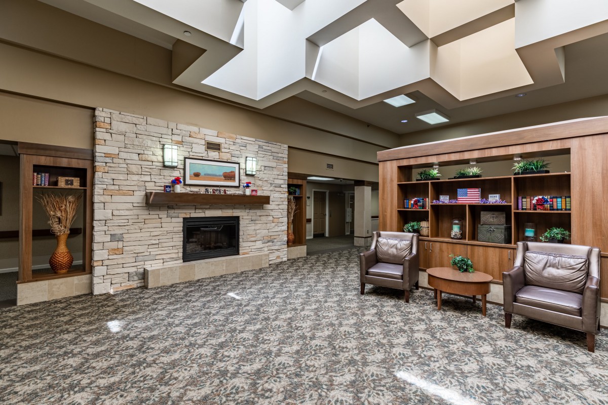 A modern lobby area featuring a fireplace and comfortable seating.