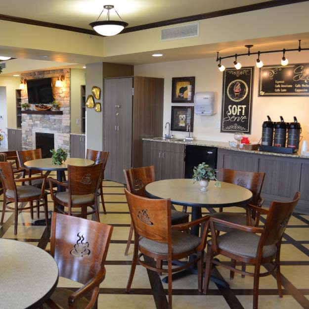 Cozy cafe interior with tables and seating area.