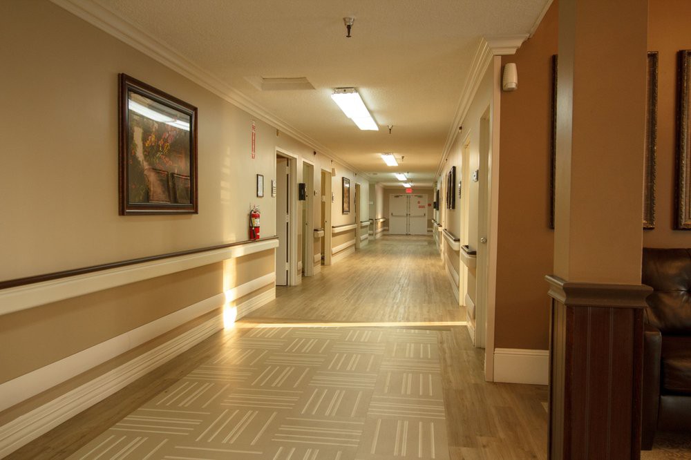 A well-lit hospital corridor with artwork on the walls.