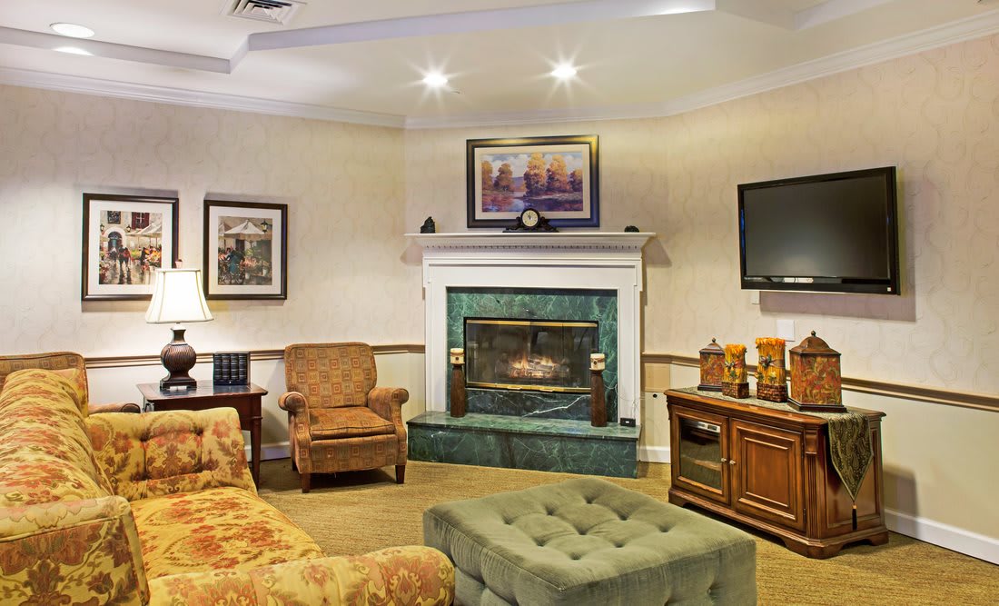 A cozy living room featuring a fireplace, comfortable seating, and elegant decor.