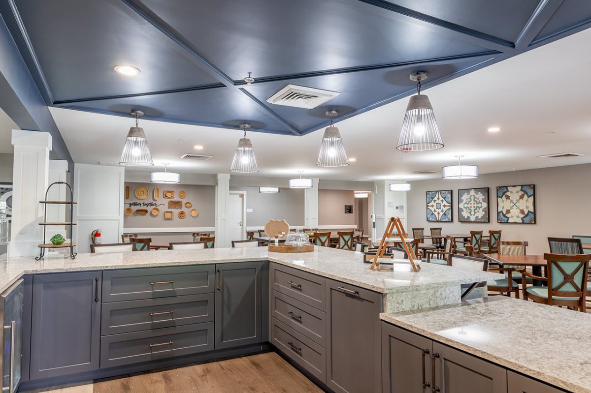 A modern kitchen with sleek cabinetry, ample lighting, and spacious countertops.