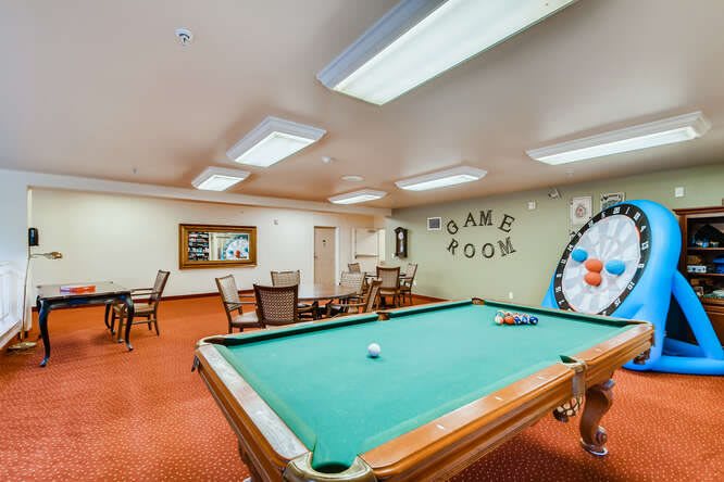 A cozy game room featuring a pool table and seating area.