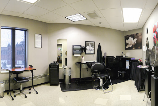 A modern and organized barber shop interior featuring styling chairs and workstations.
