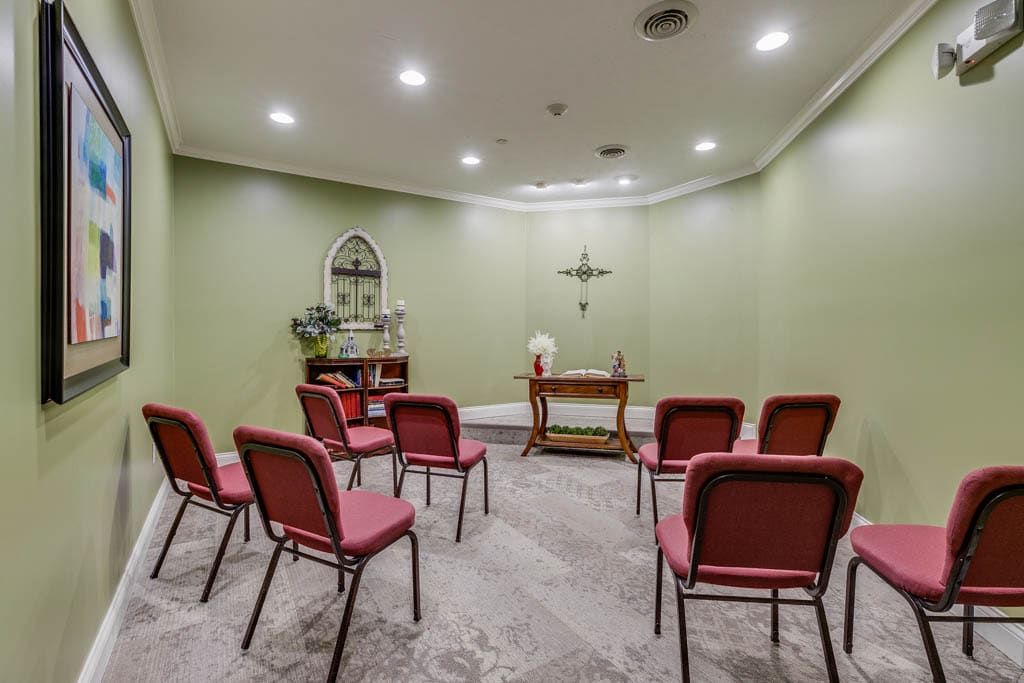 A small chapel with an altar and arranged chairs for worship.