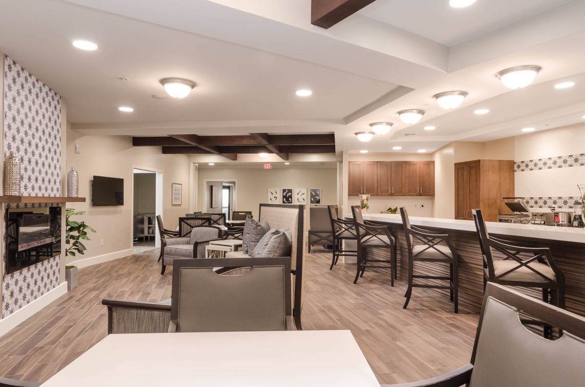 A modern open-concept living and kitchen area with comfortable seating and stylish lighting.