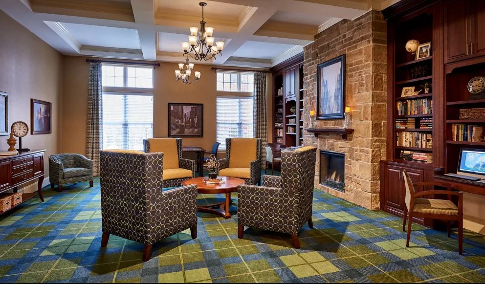 A cozy living room with a fireplace and comfortable seating arrangement.