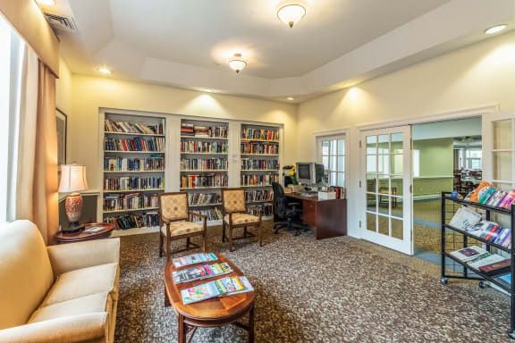 A cozy library with bookshelves and comfortable seating.