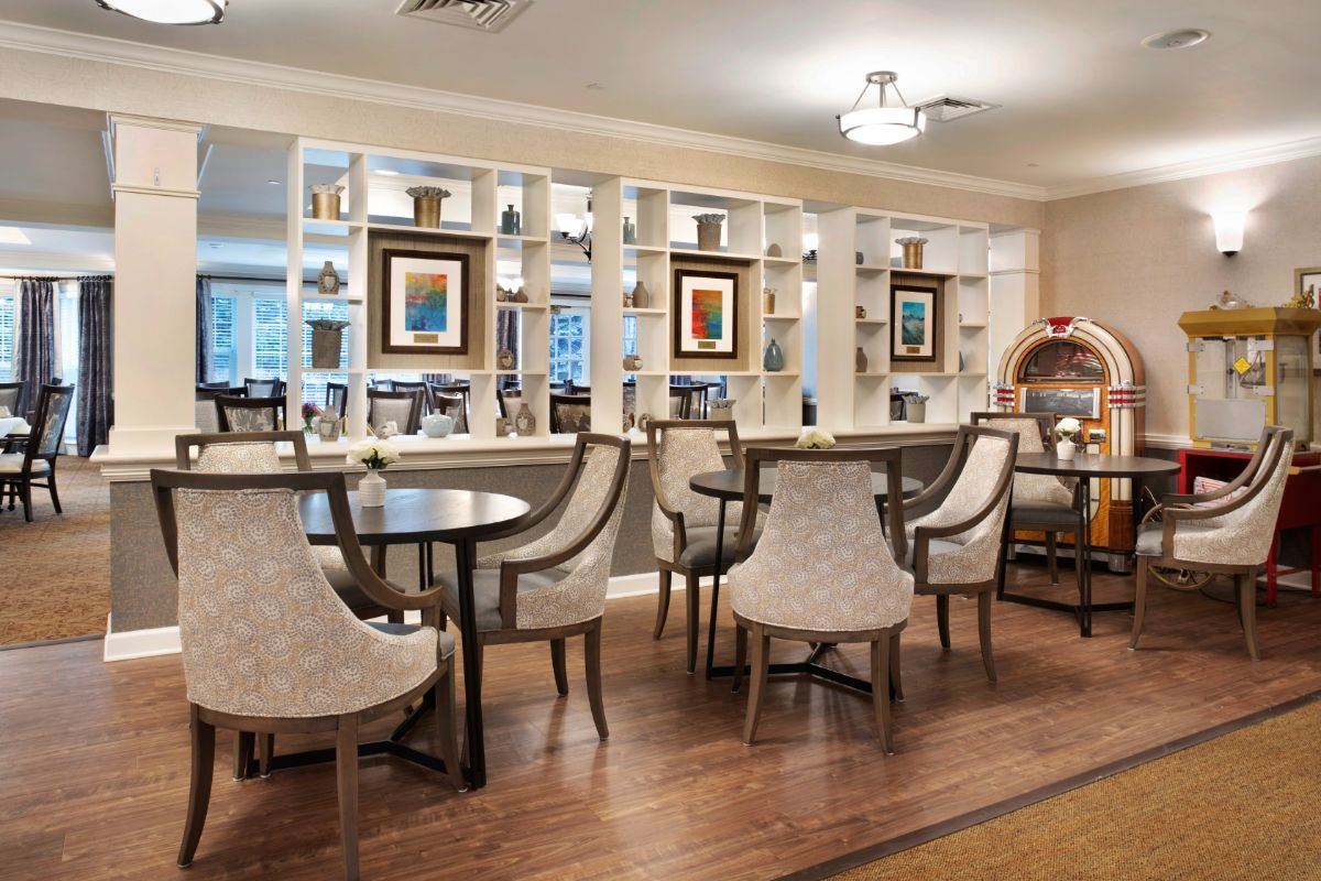 A modern library with comfortable seating and decorative artwork.