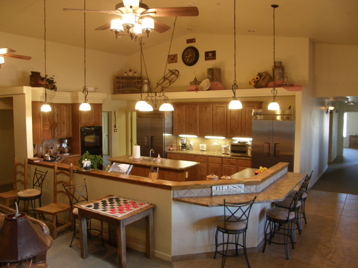 Modern kitchen with a dining area and bar seating.