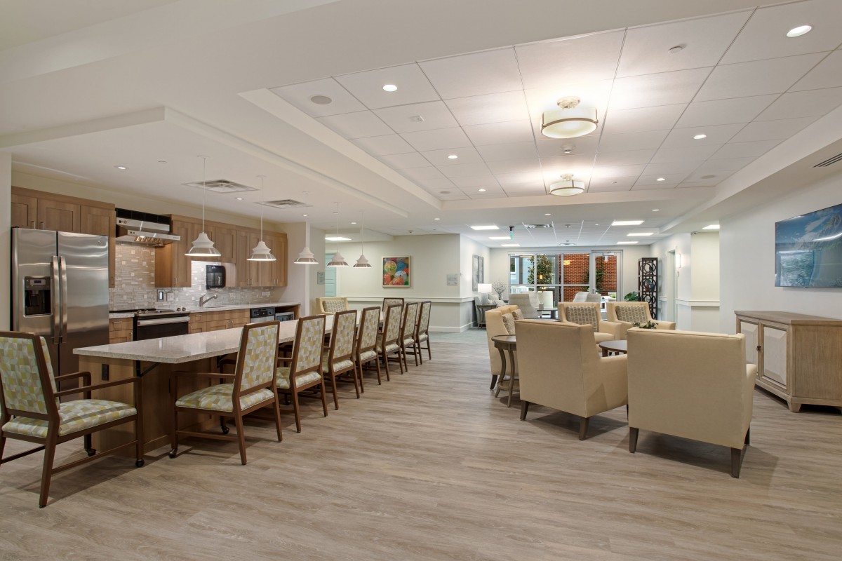 A modern dining and kitchen area with elegant seating and lighting.