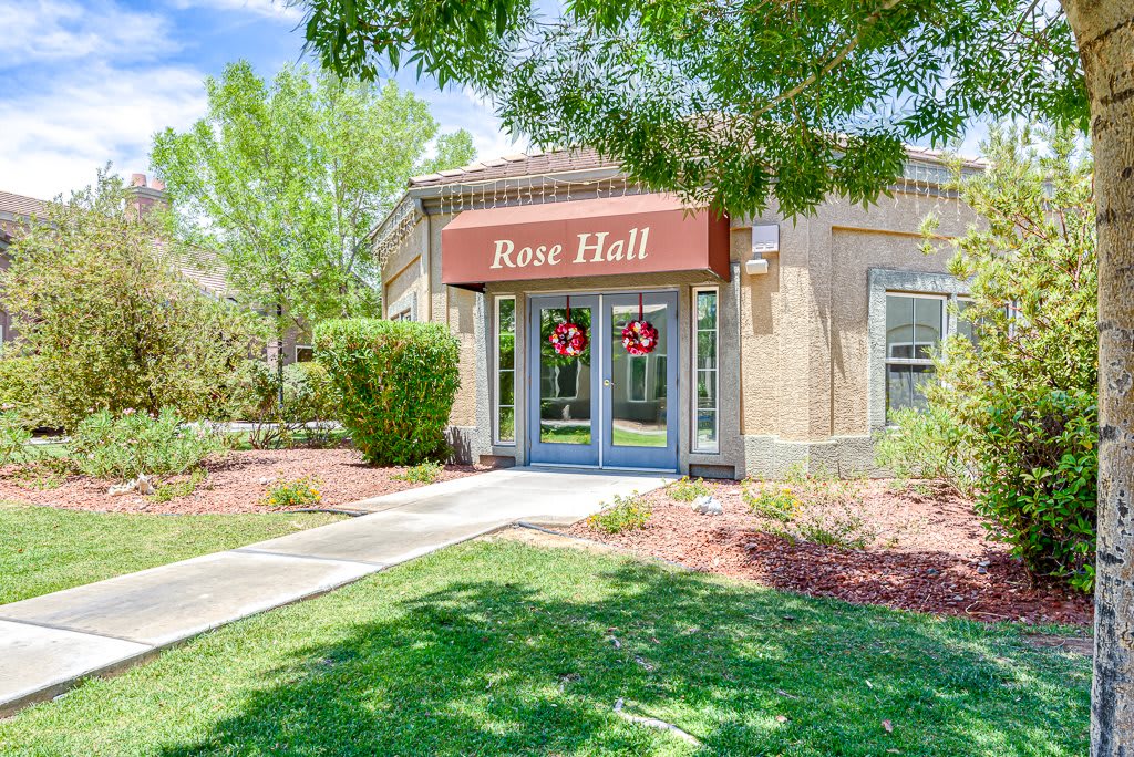 The entrance to Rose Hall with lush greenery and a well-maintained lawn.
