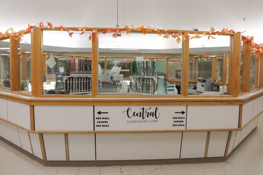 A view of a cafeteria food service counter decorated with autumn-themed elements.