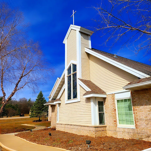 A modern church building under a clear blue sky.