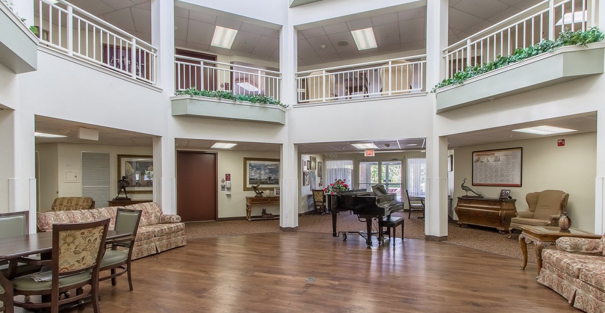 Spacious lobby area with a grand piano and seating arrangements.