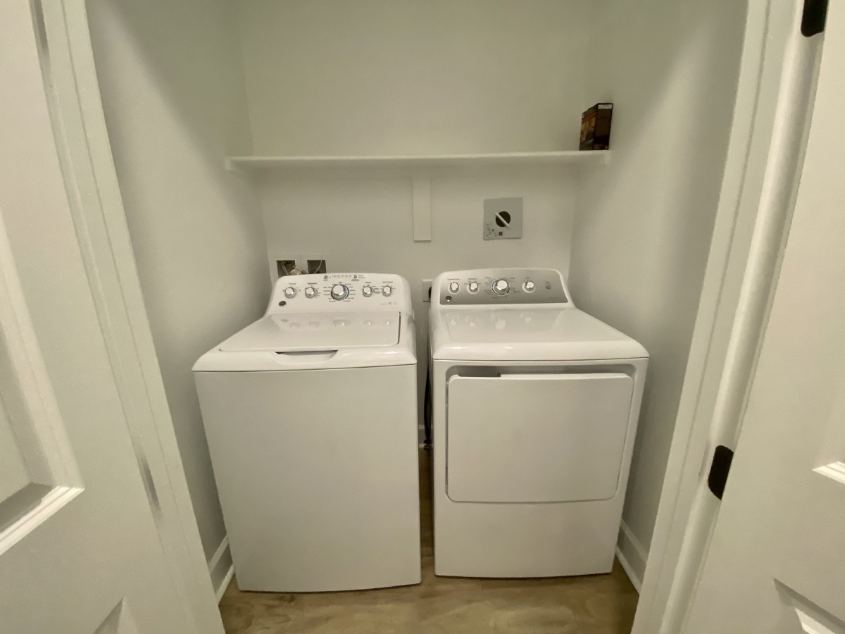 A compact laundry room with a washing machine and a dryer side by side.