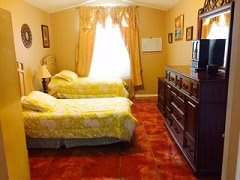 A vintage-style bedroom with twin beds and warm-colored decor.