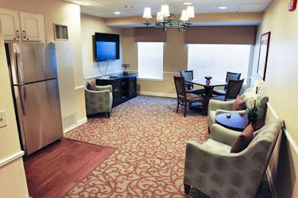 A modern living room with comfortable seating, a television, and a dining area.