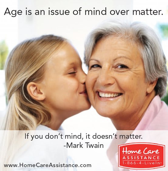 A young girl kisses an elderly woman, illustrating the quote 'Age is an issue of mind over matter. If you don't mind, it doesn't matter.' - Mark Twain.