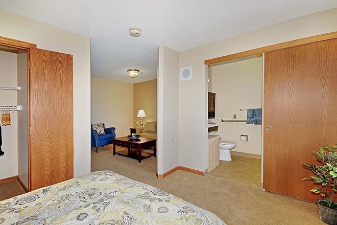 Cozy apartment interior featuring a bedroom, living area, and bathroom.