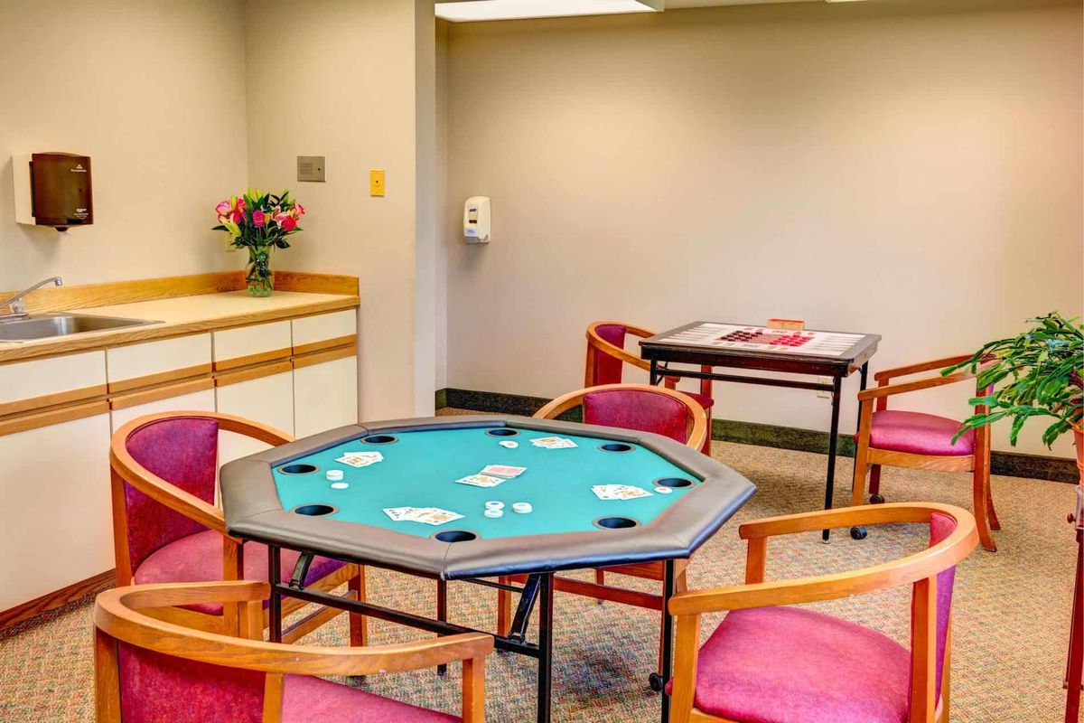A cozy game room featuring a poker table and comfortable seating.