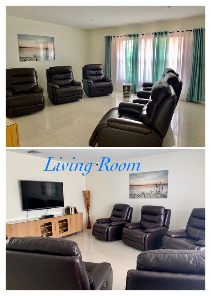 A cozy living room featuring leather recliners and a flat-screen TV.