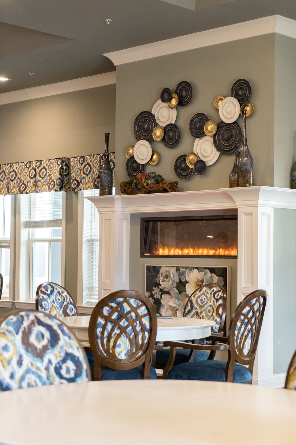 A stylishly decorated dining area featuring a modern fireplace and unique wall art.
