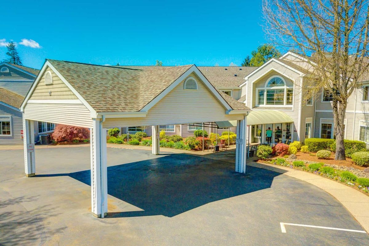 A suburban building with a covered entrance and landscaped surroundings.
