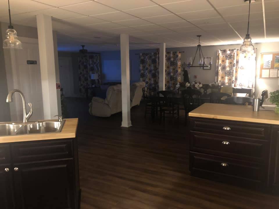 Open-concept kitchen and living area with modern furnishings.