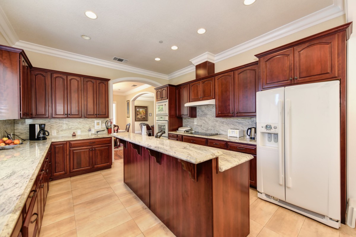 A modern kitchen with wooden cabinets and a central island.