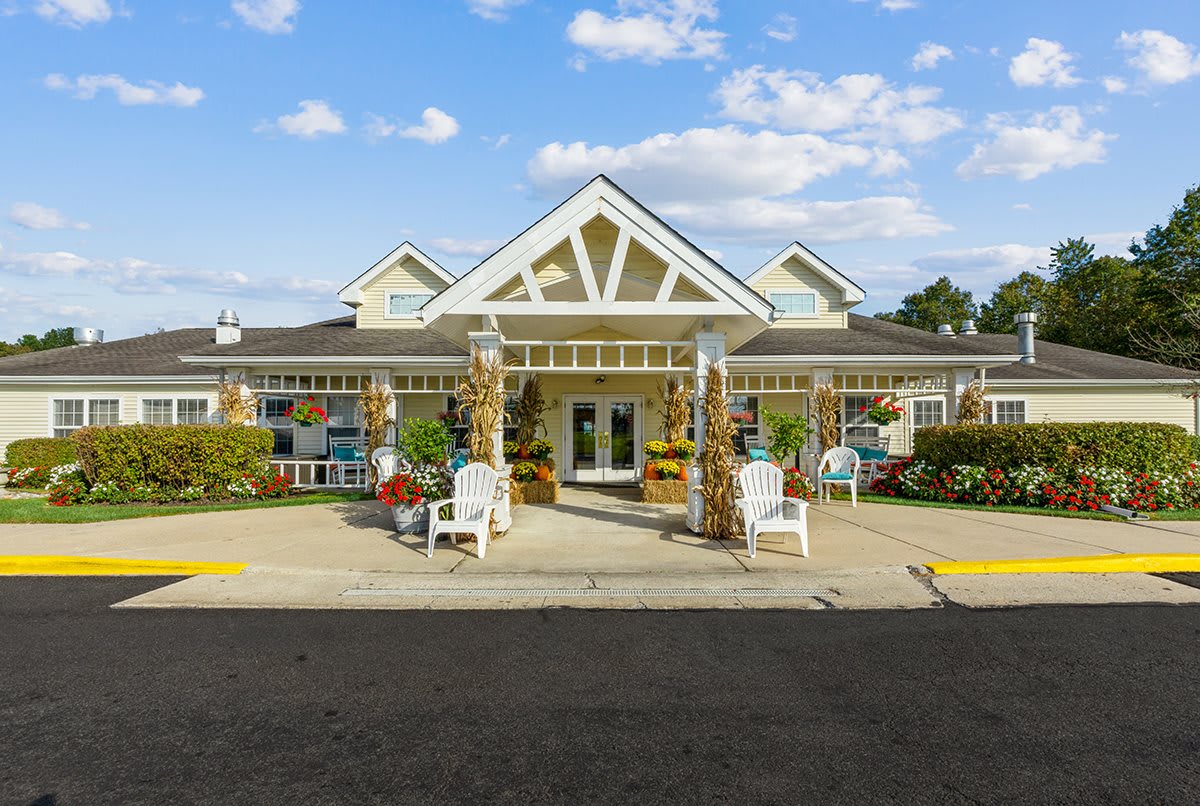 Front view of a building with a welcoming entrance decorated with seasonal items.