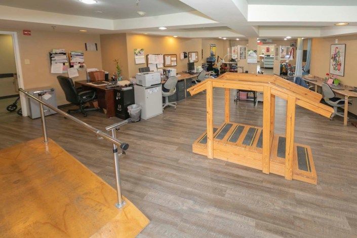 An office interior with desks, cubicles, and exercise equipment.
