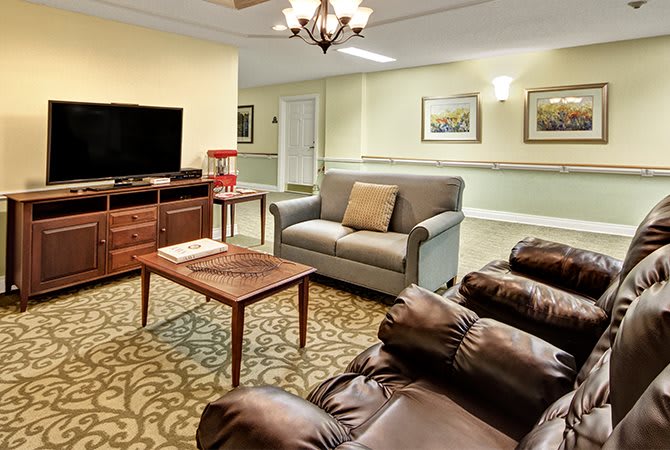 A cozy living room with comfortable seating, a television, and elegant decor.