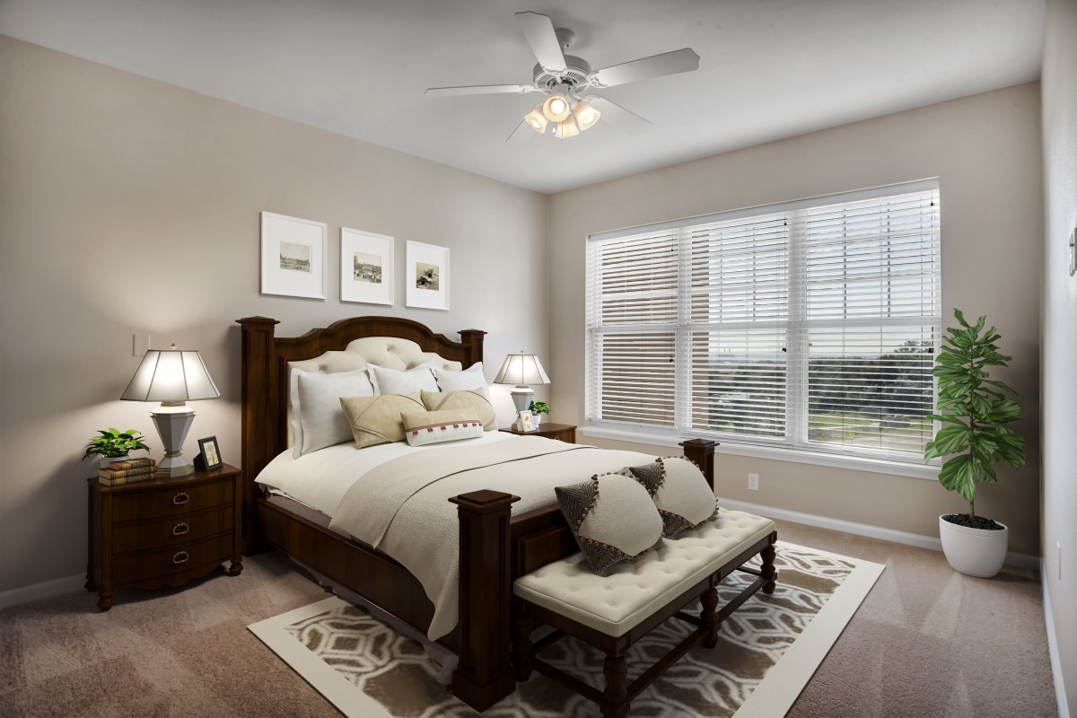 A cozy and elegantly decorated bedroom with a large window offering ample natural light.