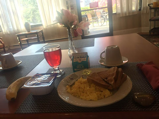 A delicious breakfast spread featuring scrambled eggs, toast, and a refreshing drink.