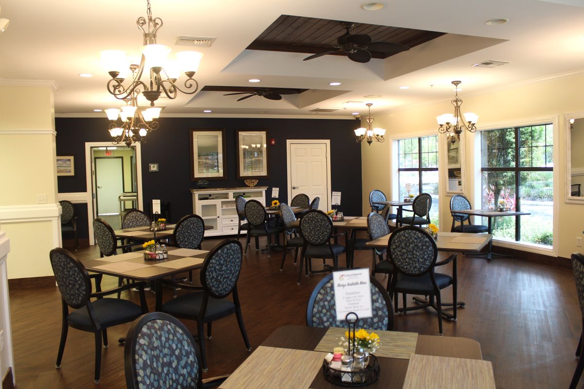 A well-decorated dining area with tables, chairs, and chandeliers.