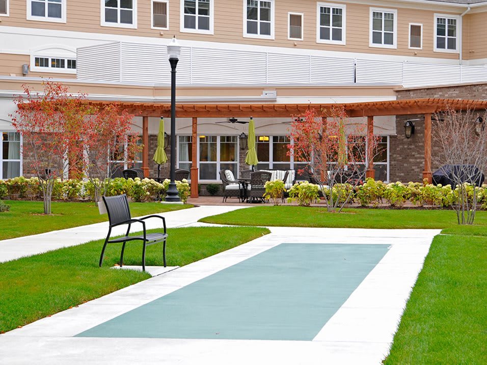 A modern building with a landscaped garden and seating area.