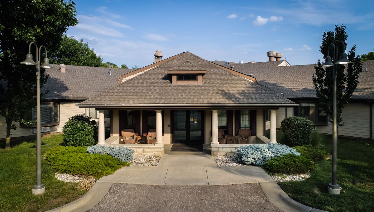 A suburban house with a welcoming porch and landscaped front yard.