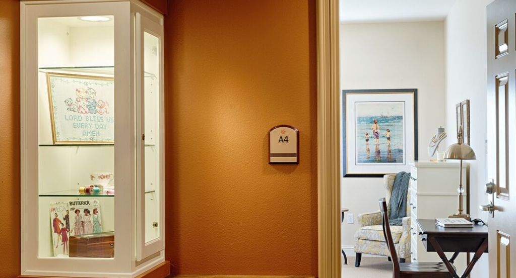A cozy interior hallway with warm lighting and artwork on the wall.