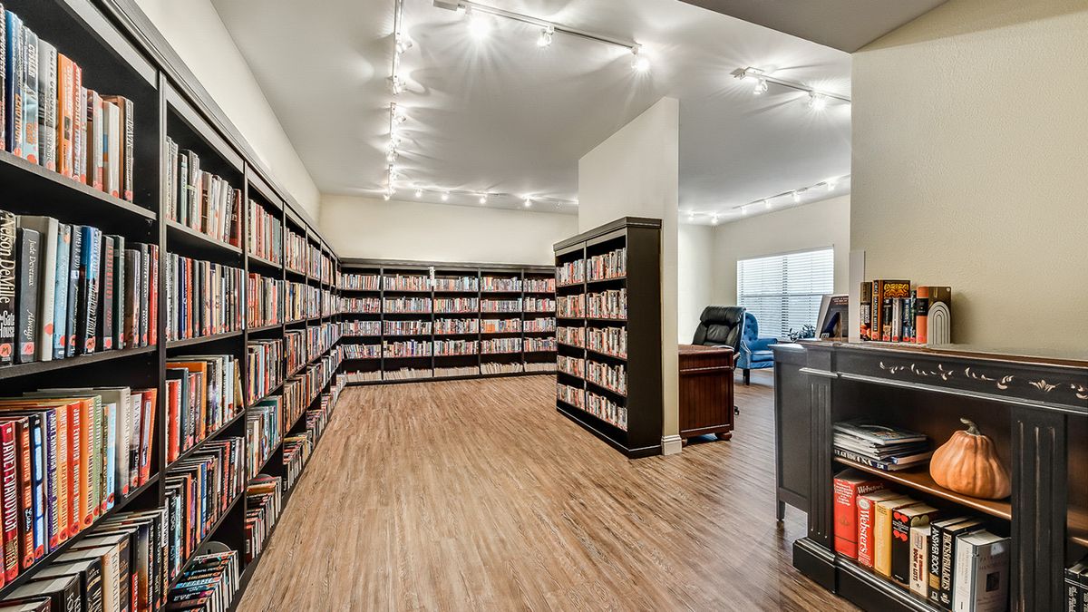 A modern library interior with neatly arranged bookshelves and a cozy reading area.