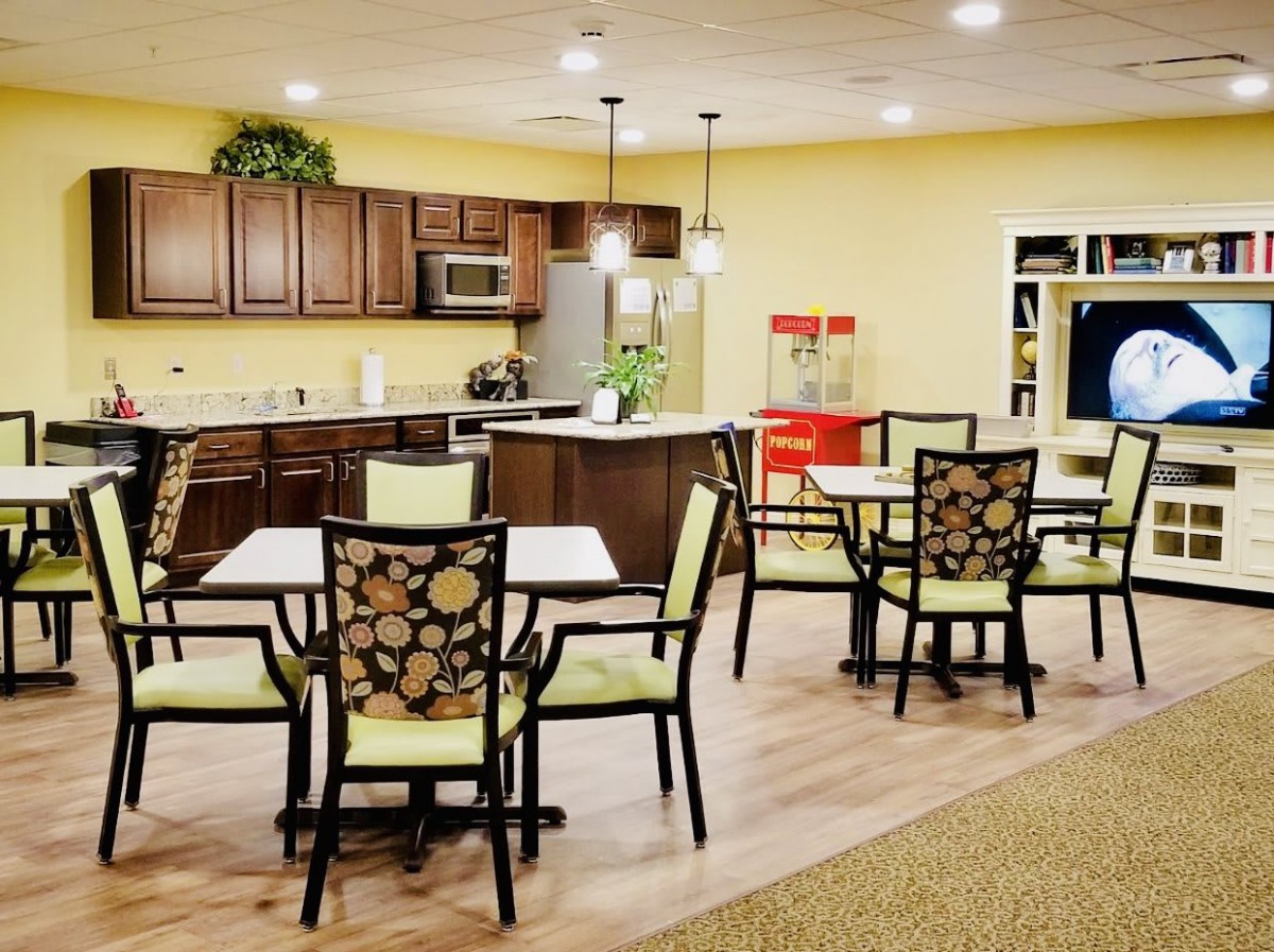 A cozy dining area with a kitchen setup and stylish seating.