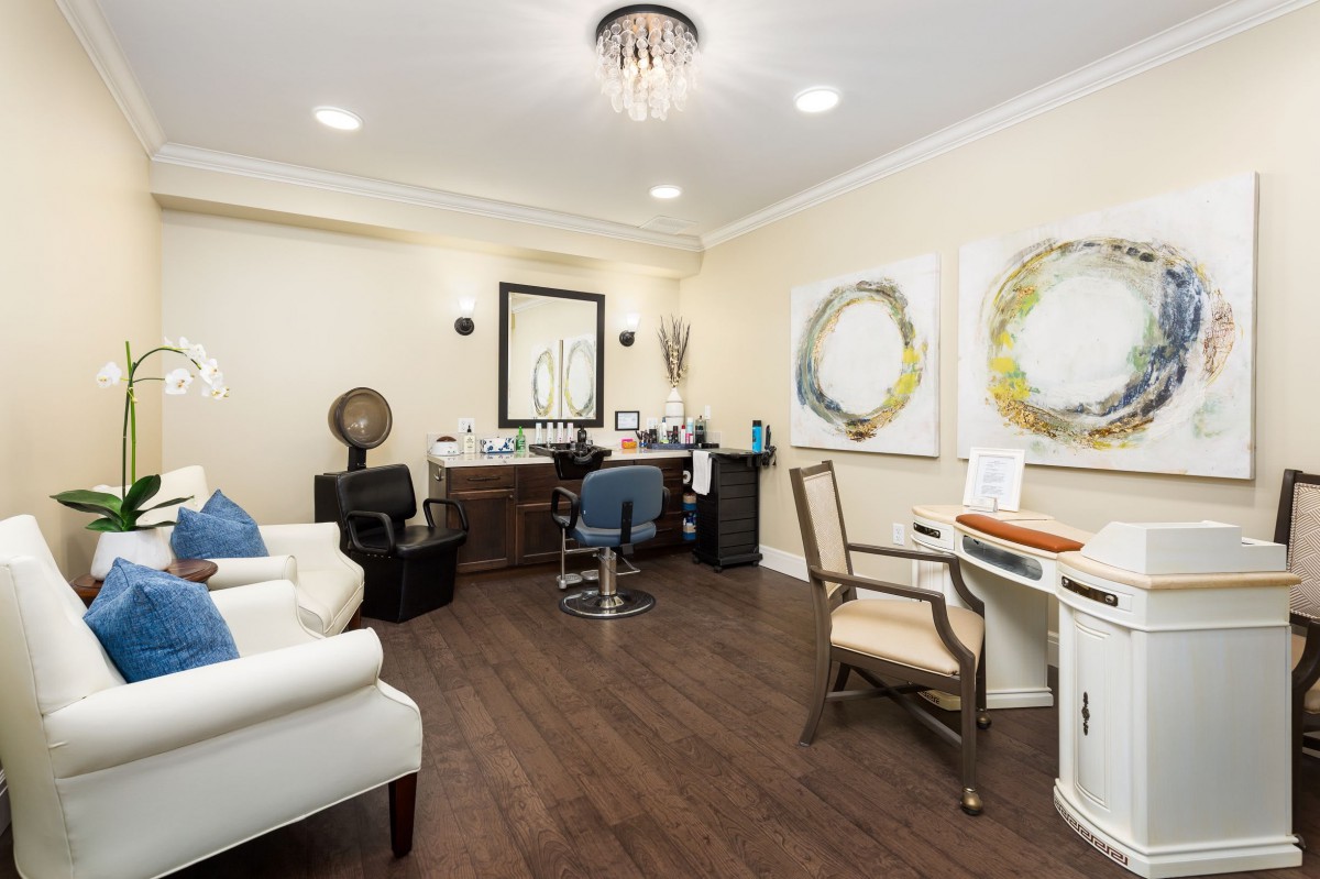 A modern hair salon with comfortable seating and stylish artwork.