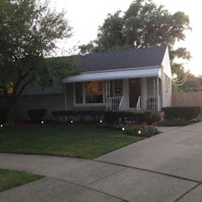A suburban house with a driveway and well-maintained front yard.