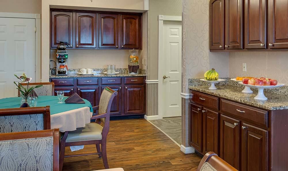 A cozy kitchen and dining area with wooden cabinets and a table set for dining.