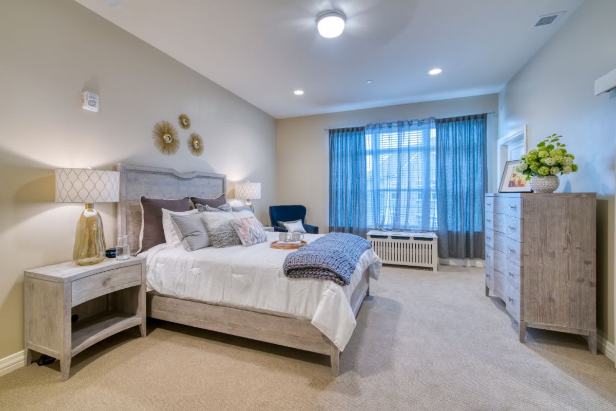 A well-decorated bedroom with modern furniture and a cozy atmosphere.