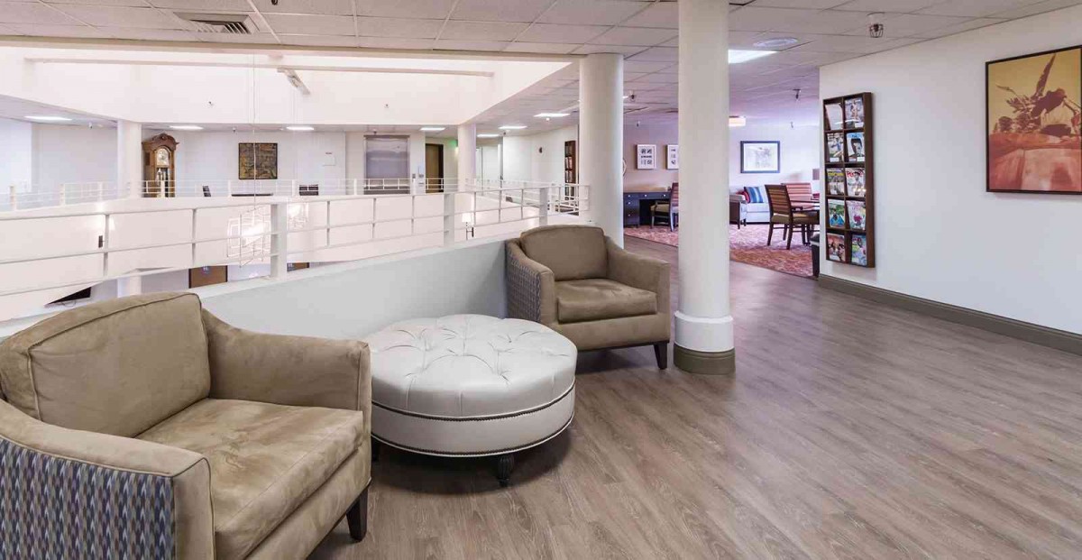 A modern interior living area with comfortable seating and a wooden floor.